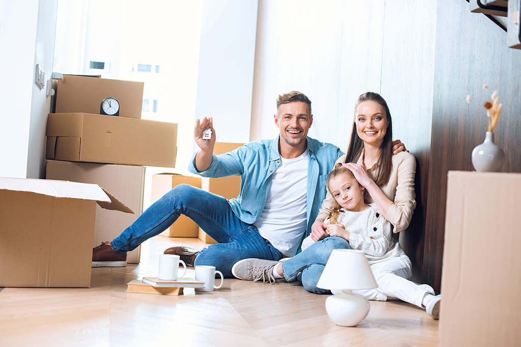 Happy family with their new home Happy family with their new home