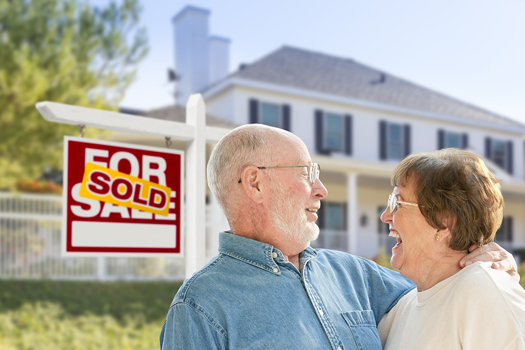 Smiling old couples infront of sold house Smiling old couples infront of sold house
