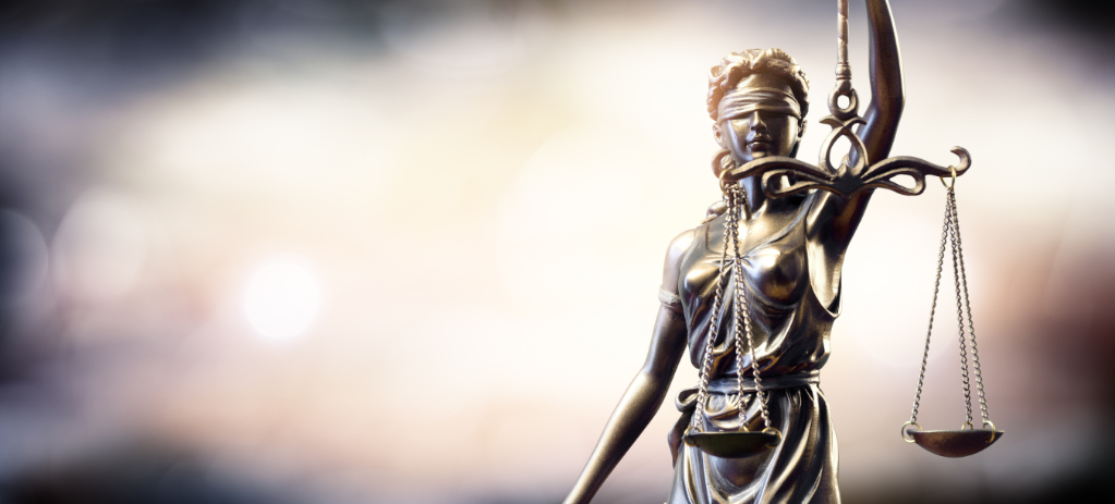 Statue Of Lady Justice On Blurred Background
