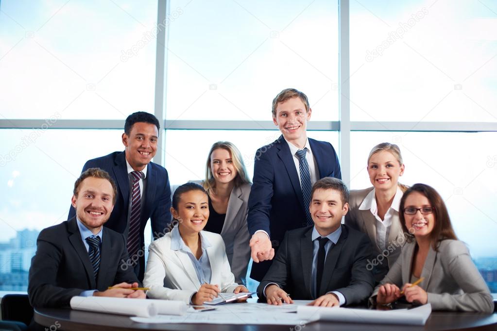 Group of business partners looking at camera with smiles in office