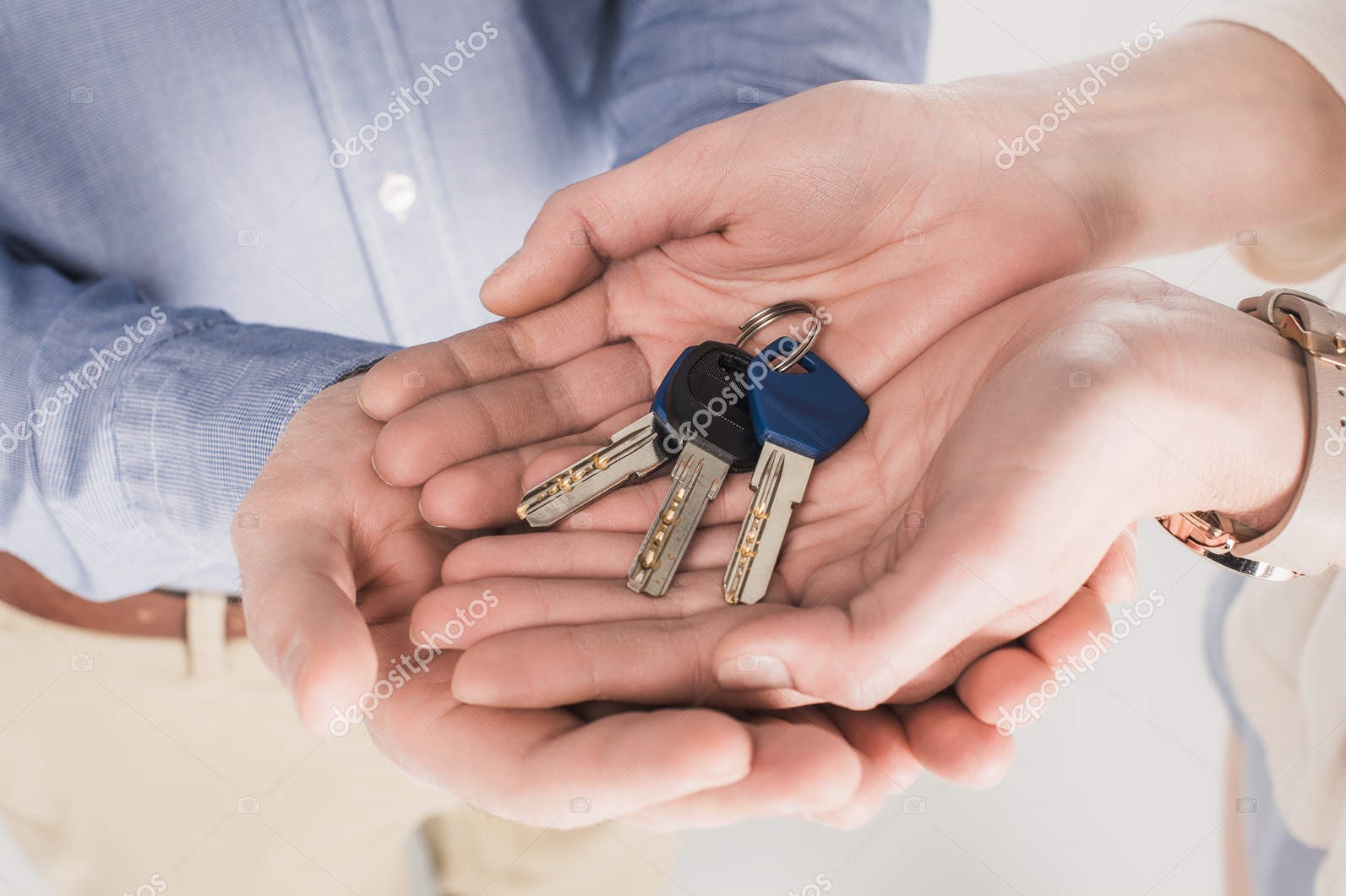 Partial view of couple holding keys from new home together